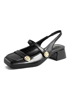 Detailed view of black square-toe Mary Jane slingback shoes with gold button accents.