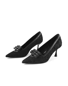 Detailed side view of black lace pointed-toe kitten heel pumps with bow accent