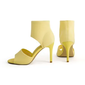 Detailed side and rear view of yellow flyknit stiletto sandals with a peep toe design