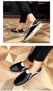 Detail van zwarte leren herenloafers met witte handmatige stiksels