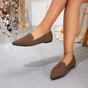 Macro detail showing the rich brown fly-knit texture of the pointed-toe flat loafers.