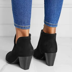 Rear detail view of women's black suede ankle boots with chunky heels and side zippers