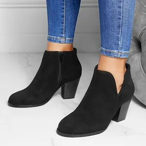 Black suede-like ankle boots with chunky heels, side zippers, and stylish V-cutouts.