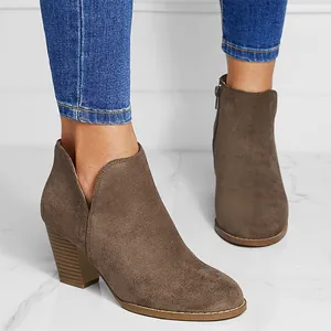 Stylish brown suede chunky heel ankle boots with side V-cutout detail worn with jeans