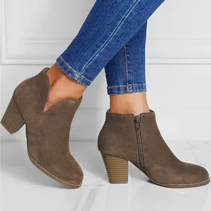 Side view of brown suede chunky heel ankle boots with round toe and side zipper details.