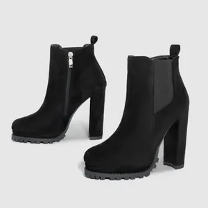 Black suede chunky high heel ankle boots with side zipper and elastic panel.