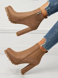Side view of brown suede chunky heel Chelsea boots with zipper and elastic detail