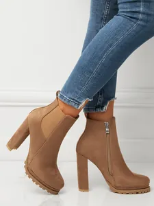 Detail view of brown suede high heel ankle boots with side zipper and elastic band