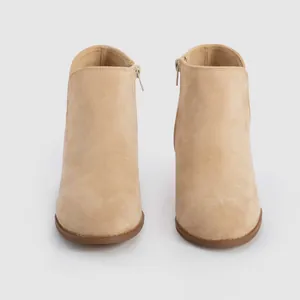 Professional front view of elegant beige suede round toe ankle boots with side zipper detail