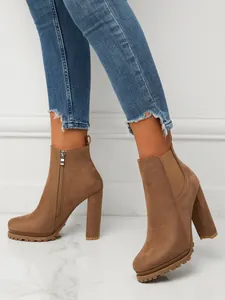Stylish brown suede chunky high heel ankle boots featuring side zipper and elastic