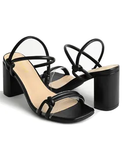 Close-up of black block heel sandals with thin straps and transparent toe band