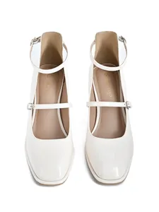 Detail view of cream patent leather Mary Jane block heels with an adjustable ankle strap