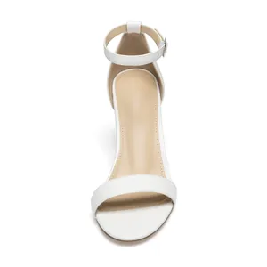 Detailed top-down view of white women's ankle strap sandals with a chunky block heel