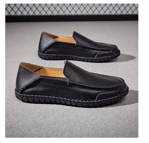 Detailed side view of premium black genuine leather loafers for men with pebble texture