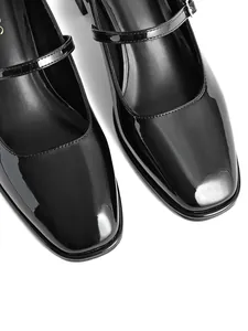 Close-up of glossy black patent leather Mary Jane shoes with square toe and buckle strap