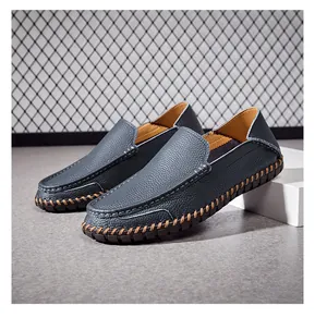 Detailed side view of blue leather loafers with heavy hand-stitched details
