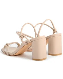 Rear detail view of beige block heel sandals with knot straps and square toe