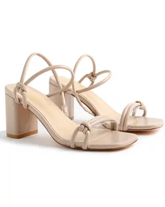 Side view of beige block heel sandals with knot straps and transparent toe band