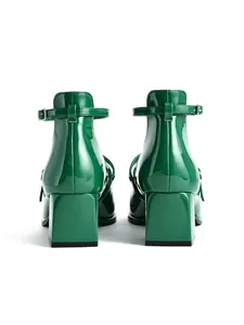 Detailed back view of elegant green patent leather Mary Jane pumps featuring square block heels