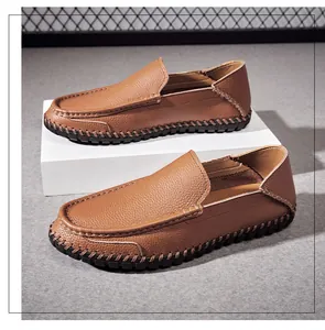 Detail view of brown textured leather loafers for men on a professional display stand