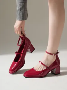 Side view of red patent leather Mary Jane shoes with square toe and chunky block heel