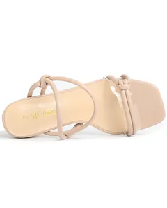 Close-up detail of a beige square toe high heel sandal featuring chic knotted straps