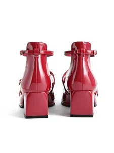 Detailed rear view showing the glossy finish and block heel of red Mary Jane shoes