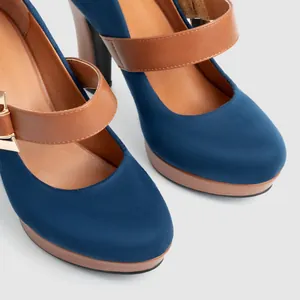 Detailed view of blue suede Mary Jane platform heels with brown straps and block heel