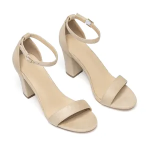 Detail view of beige suede chunky heel sandals with minimalist ankle strap.