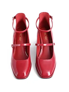Top view detail of red patent leather Mary Jane shoes with square toe and ankle straps
