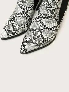 Close-up of black and white snakeskin pattern on pointed toe ankle boots