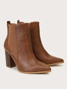 Professional detail view of brown pointed toe chunky heel ankle boots for women