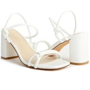 Elegant white square toe sandals featuring high block heels and knotted thin straps details