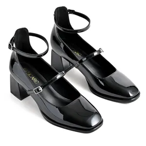Elegant black patent leather square-toe Mary Jane shoes with block heels and straps.