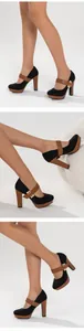 Detailed side view of black and brown Mary Jane platform shoes with chunky high heels