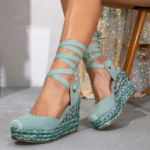 Mint green lace-up wedge sandals with rhinestone detailing and braided espadrille heel