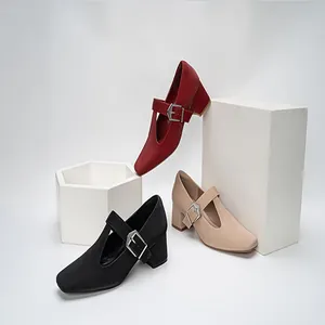 Detail view of vintage T-strap Mary Jane shoes with block heels in red, black and beige