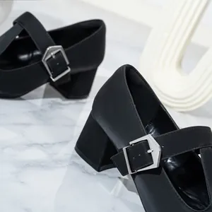 Close-up of black retro Mary Jane shoes with chunky heel and T-strap buckle detail