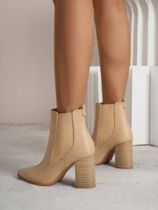 Detail of beige pointed toe chunky heel ankle boots with elastic side band for women
