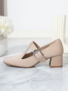 Detailed side view of elegant beige Mary Jane shoes with T-strap and silver buckle