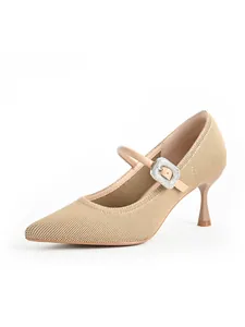 Detailed view of beige pointed-toe stiletto Mary Jane heels with rhinestone buckle