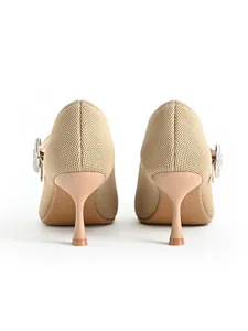 Detailed rear view of beige pointed-toe Mary Jane kitten heels with rhinestone buckle detail