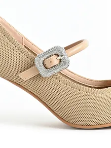 Close-up of elegant beige Mary Jane high heel with sparkling rhinestone buckle detail