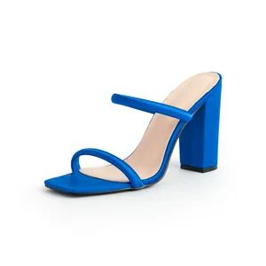 Close-up detail of the electric blue satin straps and chunky high block heel design.