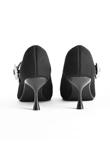 Rear view of elegant black kitten heel Mary Jane shoes with textured fabric finish.