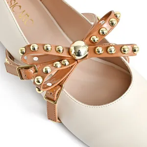 Elegant cream round toe flat shoes with brown studded bow and metal buckle straps
