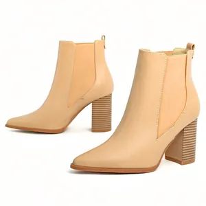 Elegant nude pointed toe chunky high heel ankle boots with elastic side panels.