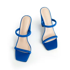 Top-down view of blue satin square toe sandals with padded straps and chunky heels