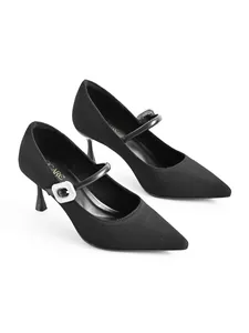 Detailed view of black knit Mary Jane heels featuring a crystal buckle and stiletto heel.