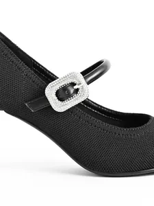 Detail of black Mary Jane heel showing the sparkling rhinestone buckle and fabric texture